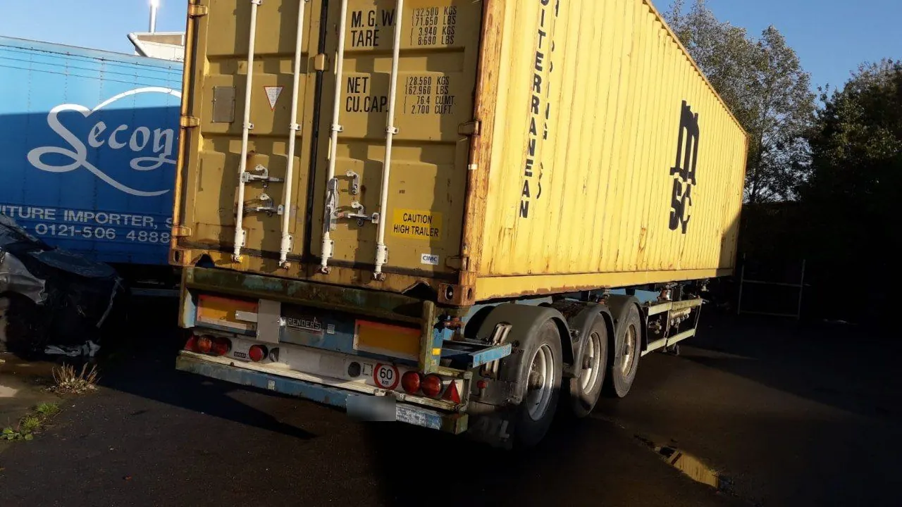 Yellow 40ft shipping container on a trailer