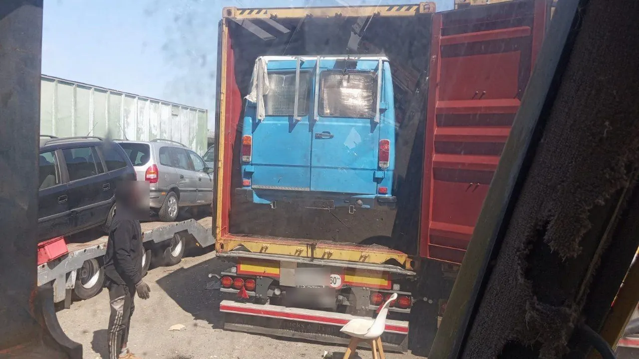 A van loaded inside a shipping container